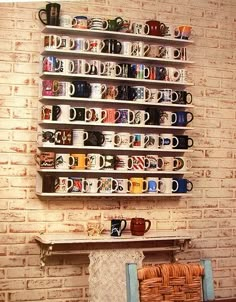 there are many mugs on the shelves in this room and one is full of coffee cups