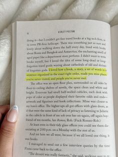 a person is holding an open book with yellow highlight on the page and it's in their left hand