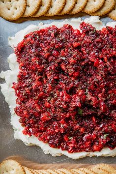 cranberry cheese appetizer on a cookie sheet with crackers