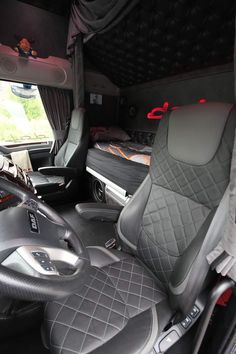 the interior of a vehicle with grey leather seats and gray carpeting on the floor