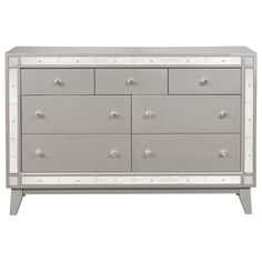 a silver and white dresser with four drawers