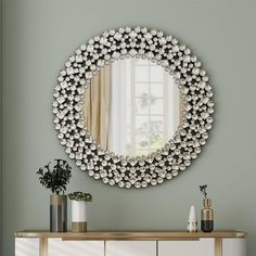 a mirror that is on the wall above a dresser