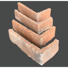 three bricks stacked on top of each other in the shape of a pyramid, with one brick missing