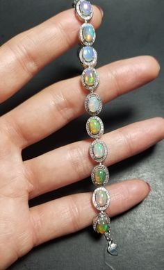 "Gorgeous high quality 100% NATURAL Opal bracelet with cubic Zirconia. Solid 925 sterling silver. Opals are 5x7mm. Oval shape. Measurements: 16cm (6.299\") Extension chain: 2cm (0.787\") Shipped in a beautiful box. Shipping within 24 hours with a tracking number and signature confirmation. Thank you very much for looking." Formal Bracelet With Halo Setting, White Gold Bracelet With Halo Setting For Wedding, Formal Bracelet Jewelry With Halo Setting, Sterling Silver Diamond Bracelet With Gemstone, Fine Jewelry Bracelets With Halo Setting For Gift, Diamond Bracelets With Halo Setting As Gift, White Gold Bracelets With Halo Setting And Cubic Zirconia, Formal Halo Setting Bracelet Jewelry, Silver Tennis Bracelet With Halo Setting For Anniversary