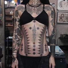 a woman with tattoos on her body and chest