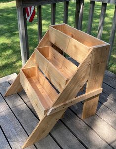 a wooden bench sitting on top of a wooden deck