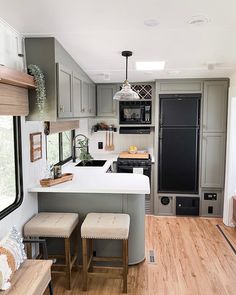 a kitchen with an island and stools next to the counter top in a home