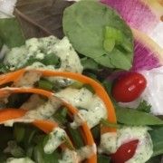 a salad with carrots, lettuce and tomatoes