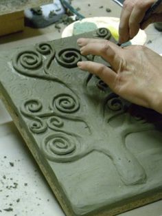 a person is working on something with clay