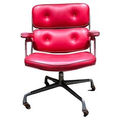 an office chair with red leather upholstered to the seat and back, viewed from the front