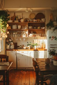 a kitchen filled with lots of wooden furniture and white cabinets next to a dining room table