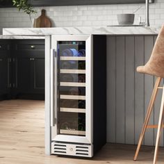 a wine cooler sitting in the middle of a kitchen