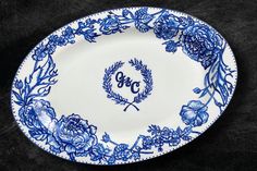 an ornate blue and white plate with the word go written in cursive writing