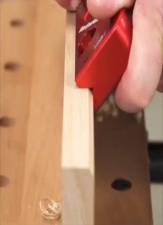 a person using a piece of wood to work on a piece of wood with a planer