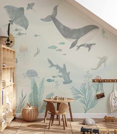 a child's room with an ocean theme painted on the wall and wooden flooring