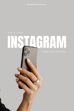 a woman holding up her cell phone to take a photo with the instagram logo