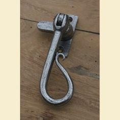 a metal hook on the side of a wooden floor