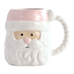 a ceramic mug with a santa claus face on it's side and a pink nose