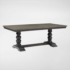 a wooden table with black legs and an old style design on the top, against a white background