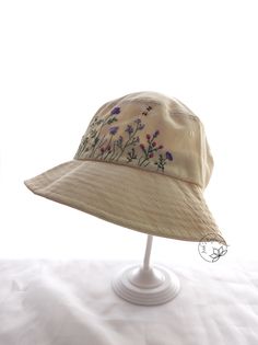 a white hat with purple flowers on it