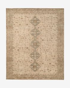 an antique rug with many different colors and patterns on the carpet, including beiges and browns