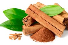 cinnamon sticks, cinnamon powder and green leaves