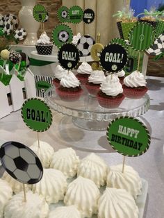 cupcakes with soccer decorations on them are sitting on a cake plate at a sports themed birthday party