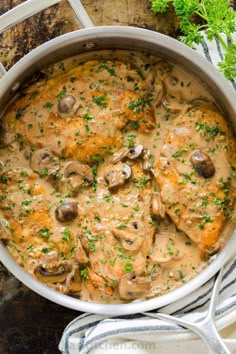 chicken with mushrooms and gravy in a white pot