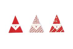 three red and white paper christmas trees with santa's faces on them, one in the