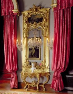 an ornately decorated room with red drapes