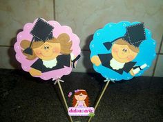 there are two cake toppers that look like they have graduation hats on them