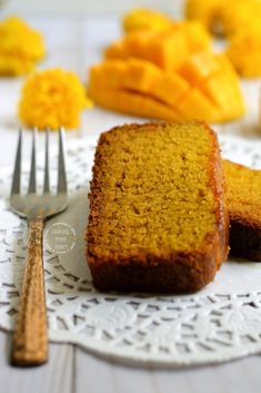 two slices of cake sitting on top of a white doily next to silverware