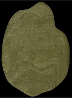 an oval shaped rug with wavy lines on the top and bottom, in olive green