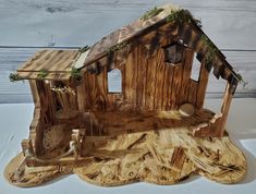 a small wooden house made out of wood on top of a piece of driftwood