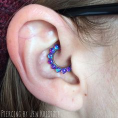 a woman wearing a pair of ear piercings