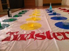 a table that has some cups on it with the word twister painted on it