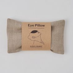 the eye pillow is made from linen and has a brown label on it that says eye pillow