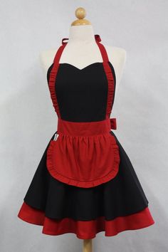 a black and red apron dress on a mannequin headdress with white trim