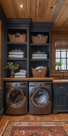 a washer and dryer in a room with wooden floors, built - in shelving