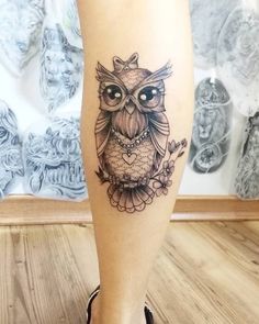 an owl tattoo on the leg