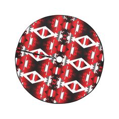 a red and white clock with an abstract design on the face, which is made up of