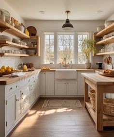 a kitchen filled with lots of wooden shelves