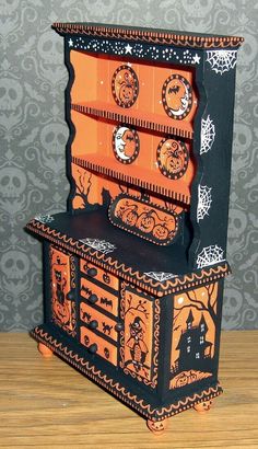 an orange and black dresser with halloween decorations on it