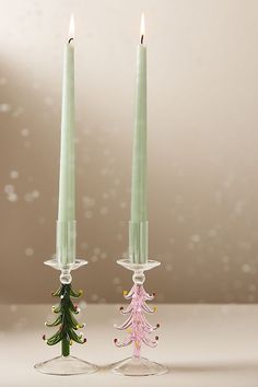 two candles sitting next to each other on a table