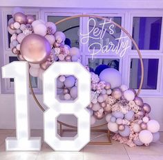 the number eighteen is surrounded by balloons and flowers