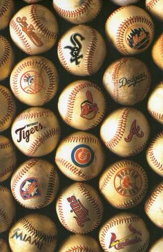 many baseballs with different logos on them