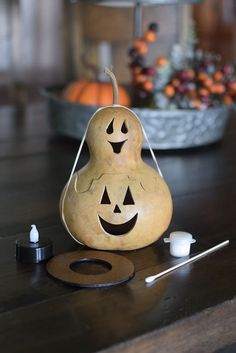 a pear with two faces on it sitting on a table next to an earpiece