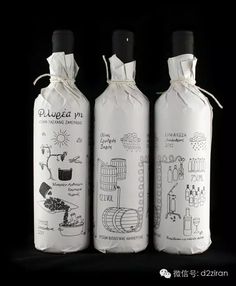 three bottles with drawings on them sitting side by side in front of a black background