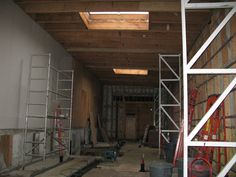 an unfinished room with scaffolding and ladders