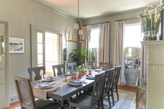 the dining room table is set with place settings